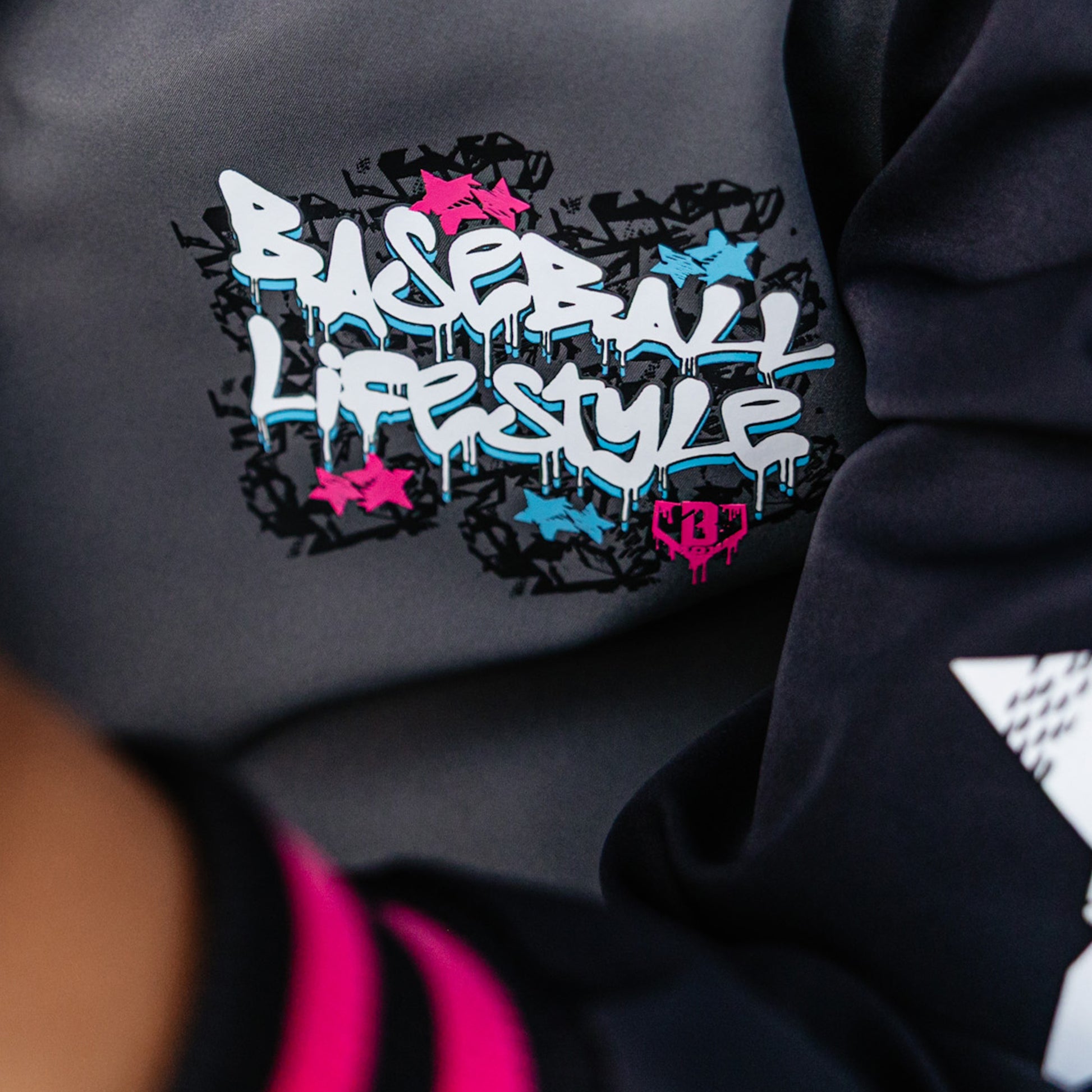 Black sweatshirt with colorful Baseball Lifestyle text design on a dark background