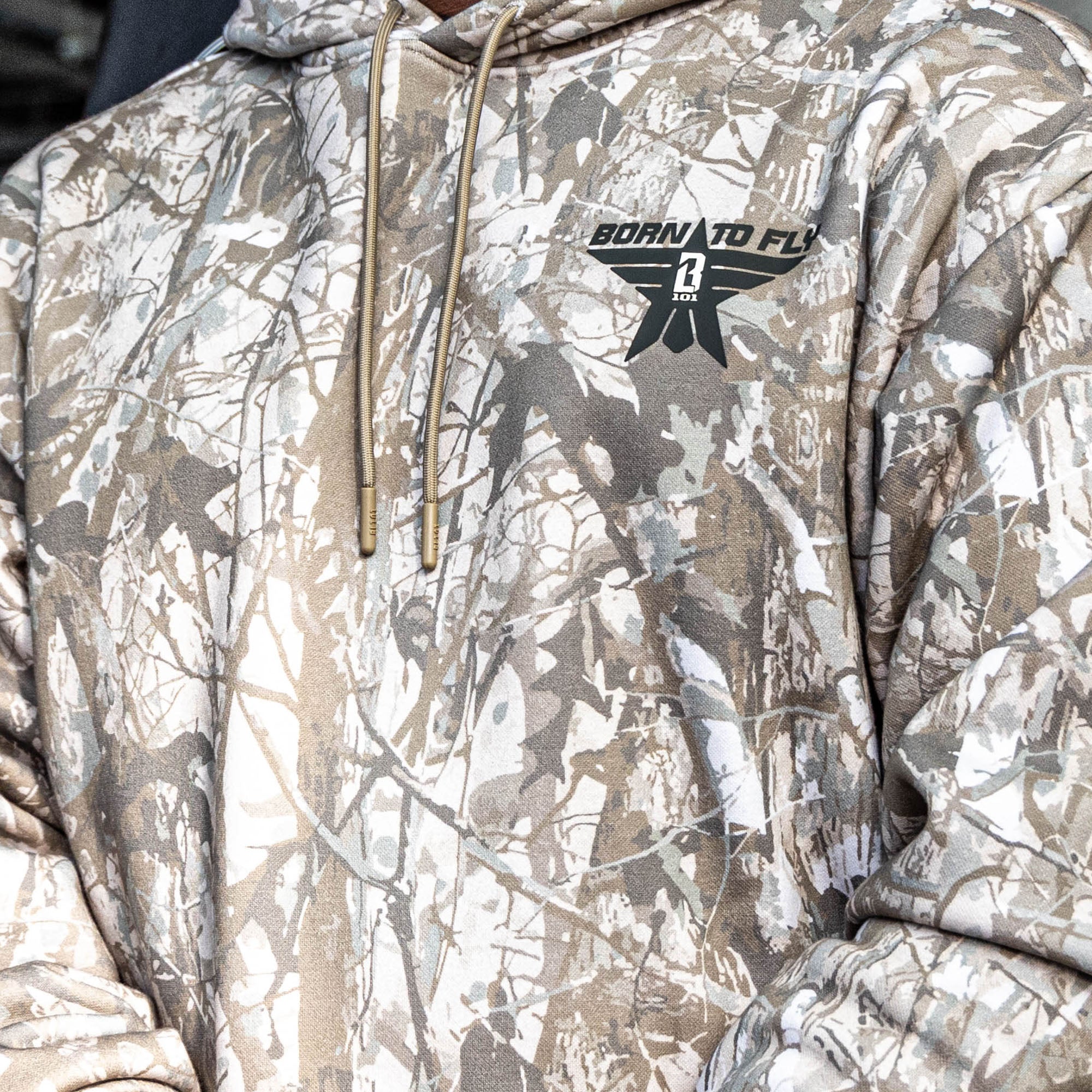 Close up of Camouflage hoodie with a brand logo on a neutral background