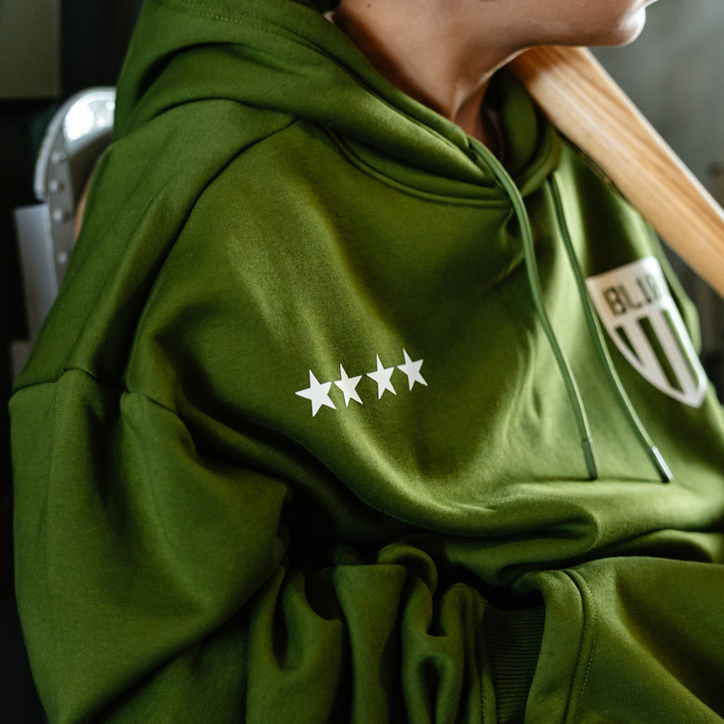 Youth model wearing green Flight Deck Army Green youth hoodie