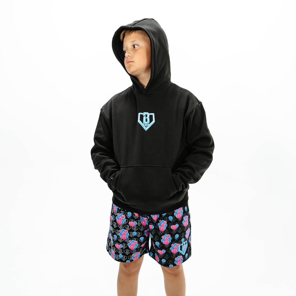 Youth model wearing black youth hoodie with "10 Year Anniversary" design
