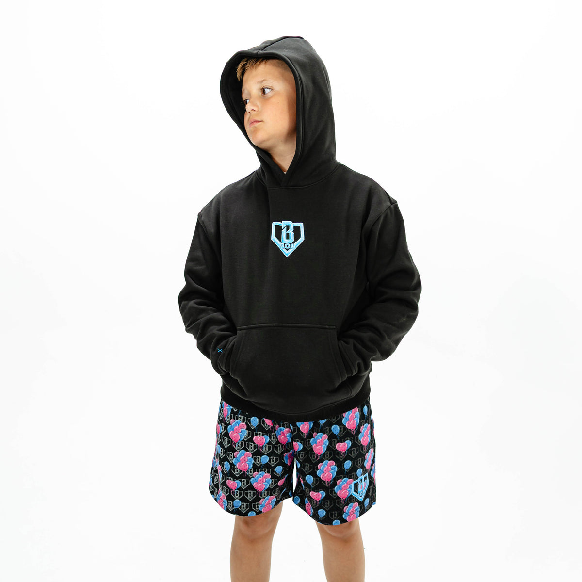 Youth model wearing black youth hoodie with "10 Year Anniversary" design