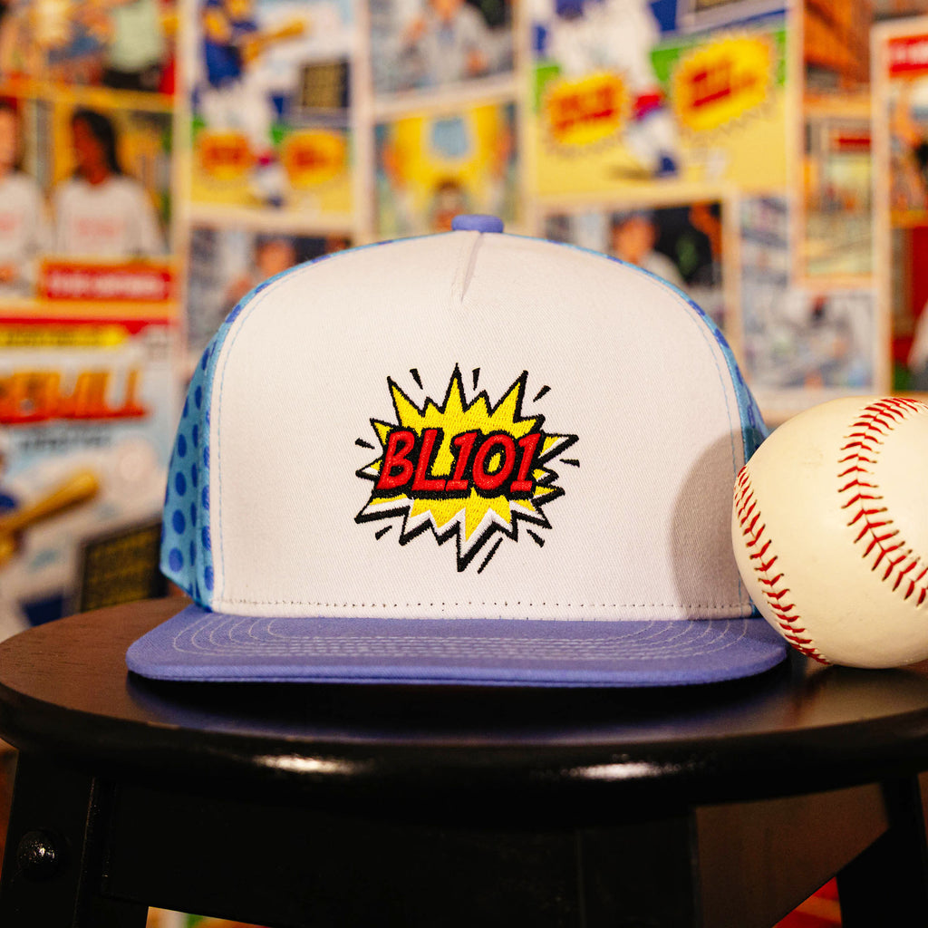 Youth model wearing blue hat with "BL101 Comic" design