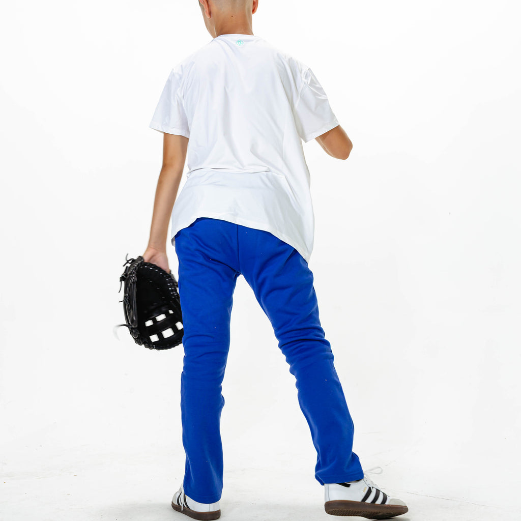 Youth model wearing Blue Baseline Straight Leg sweatpants
