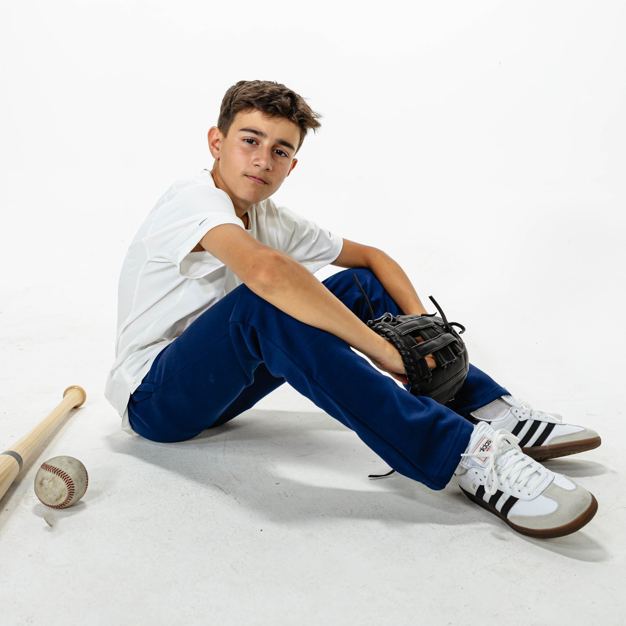Youth model wearing Navy Baseline Straight Leg sweatpants