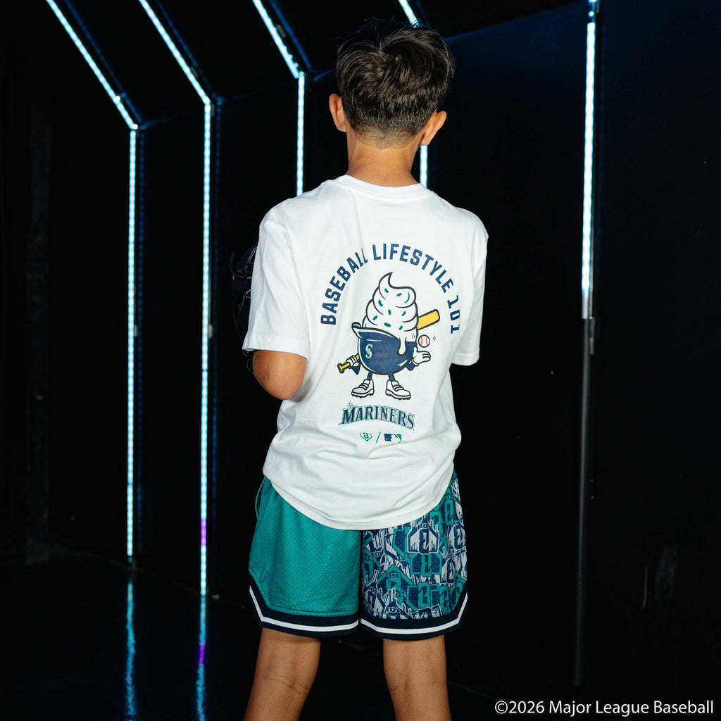 Youth model wearing green youth shorts with "Seattle Mariners Sticker Court" design
