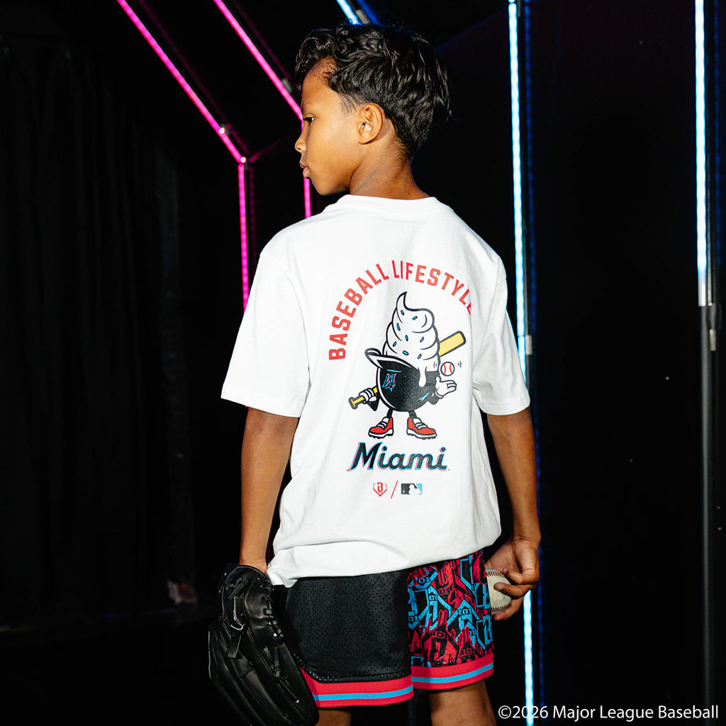 Youth model wearing black youth shorts with "Miami Marlins Sticker Court" design