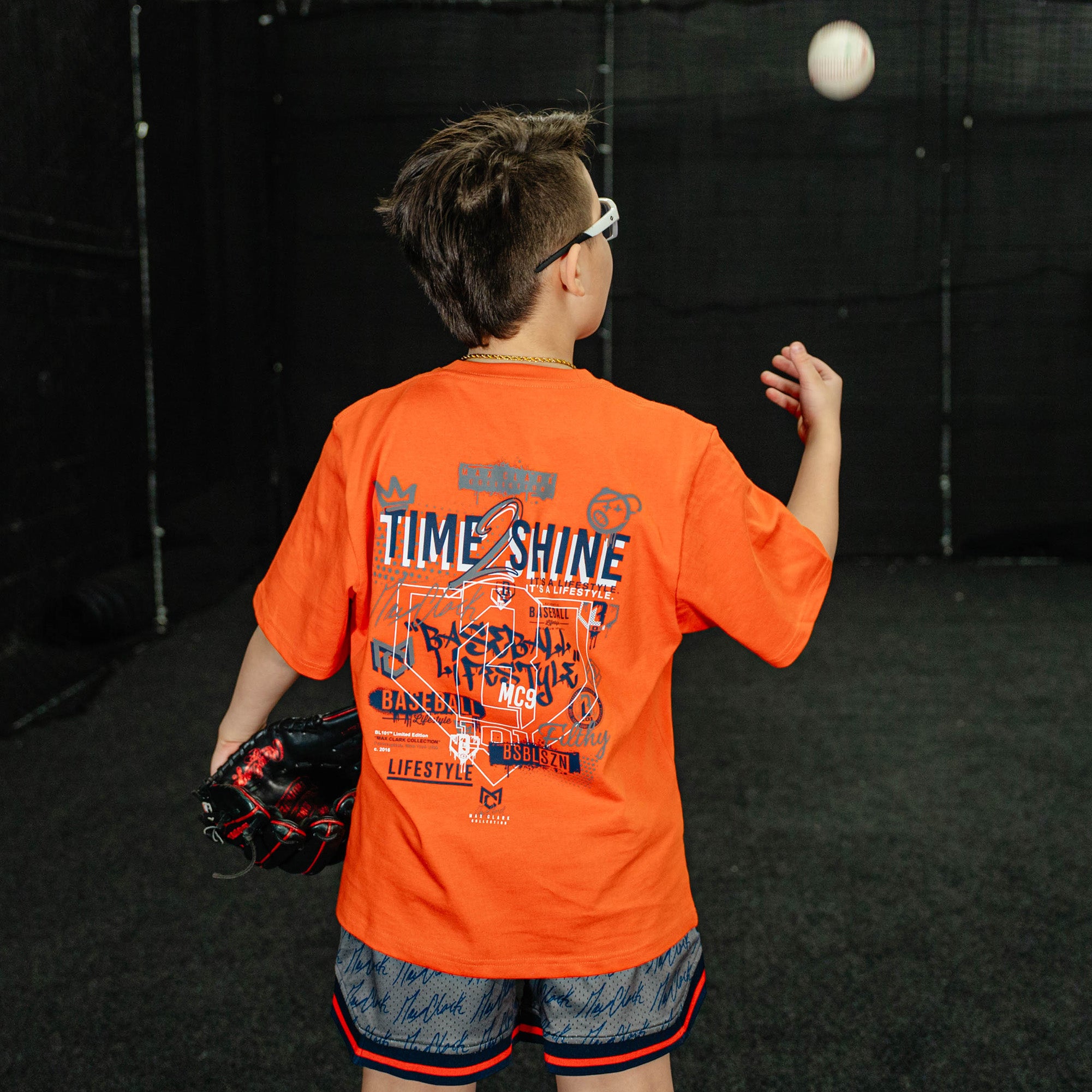 Person in an orange shirt playing with a ball indoors