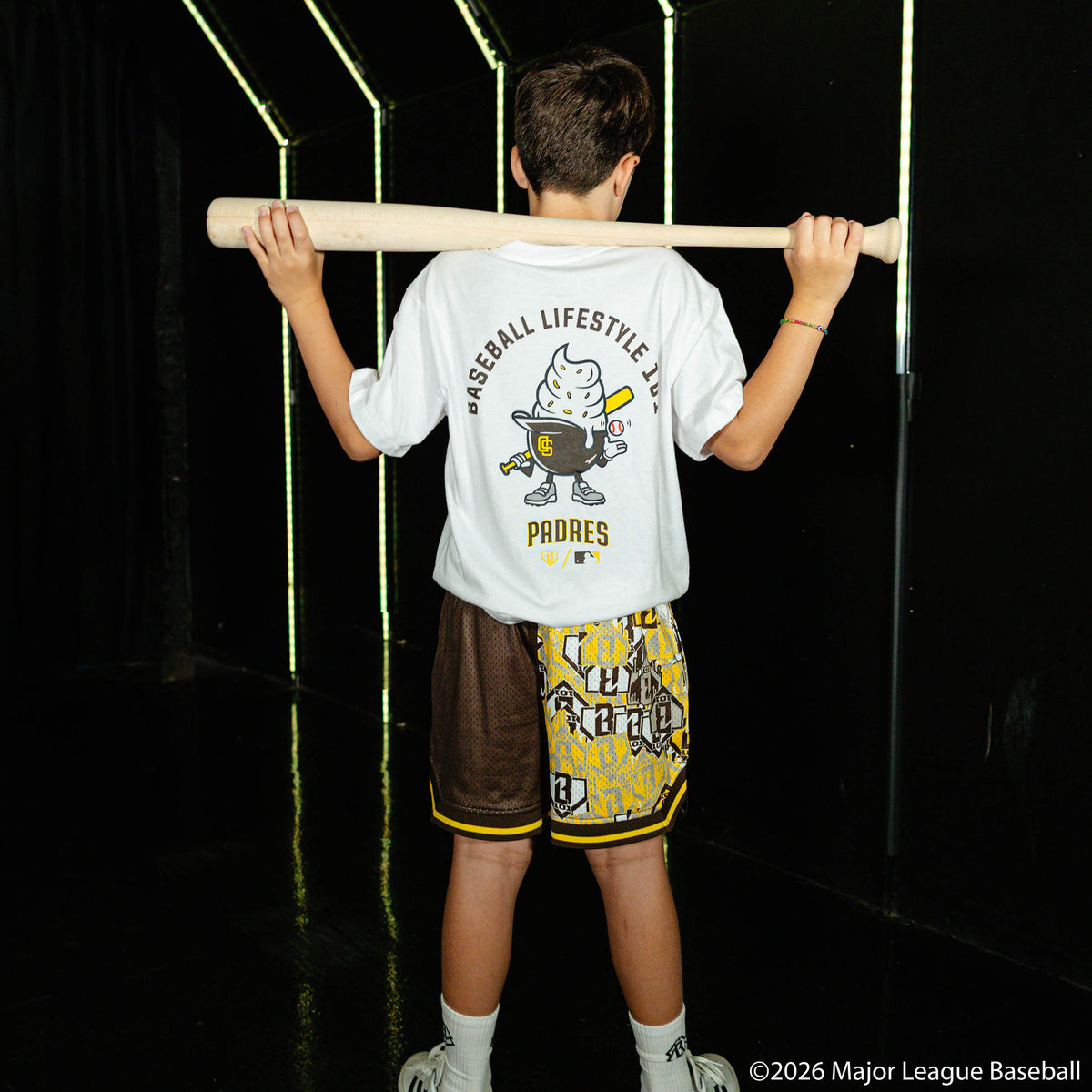Youth model wearing youth shorts with "San Diego Padres Sticker Court" design