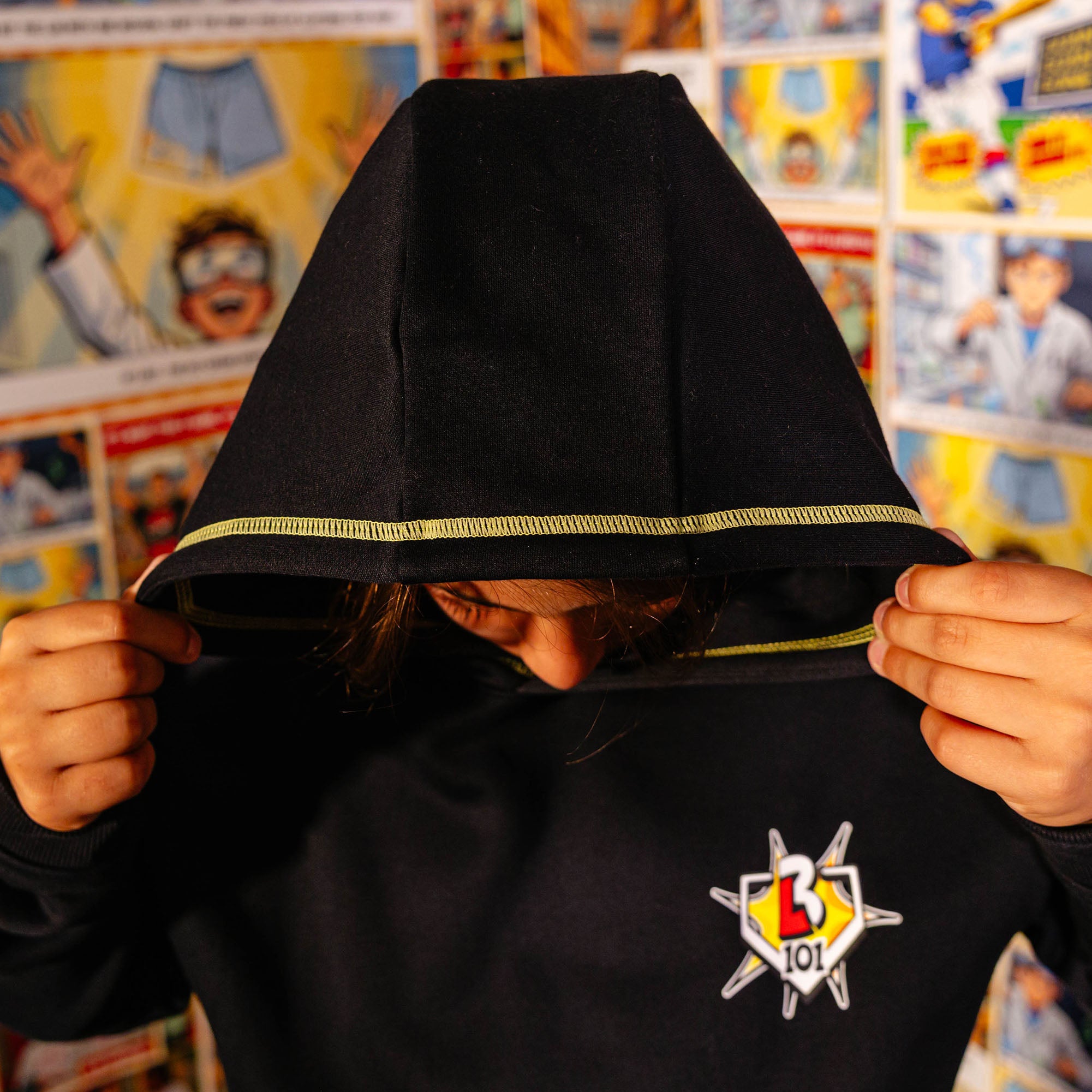 Youth model wearing black youth hoodie with "Power Hitter" design
