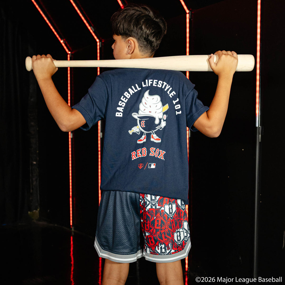 Youth model wearing navy youth shorts with "Boston Red Sox Sticker Court" design