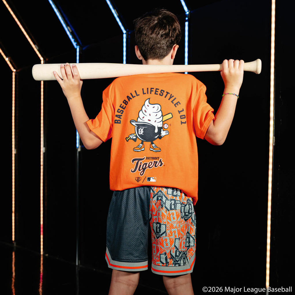 Youth model wearing navy youth shorts with "Detroit Tigers Sticker Court" design