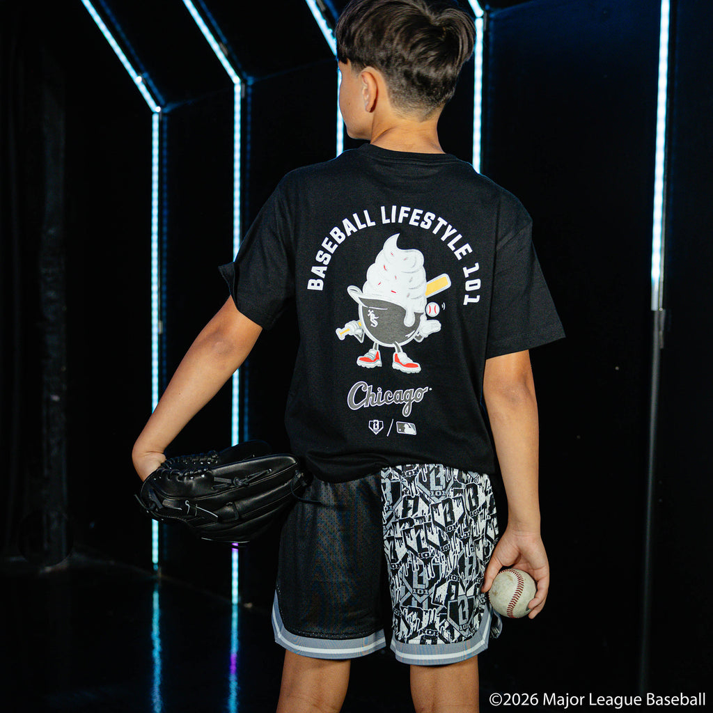 Youth model wearing black youth shorts with "Chicago White Sox Sticker Court" design