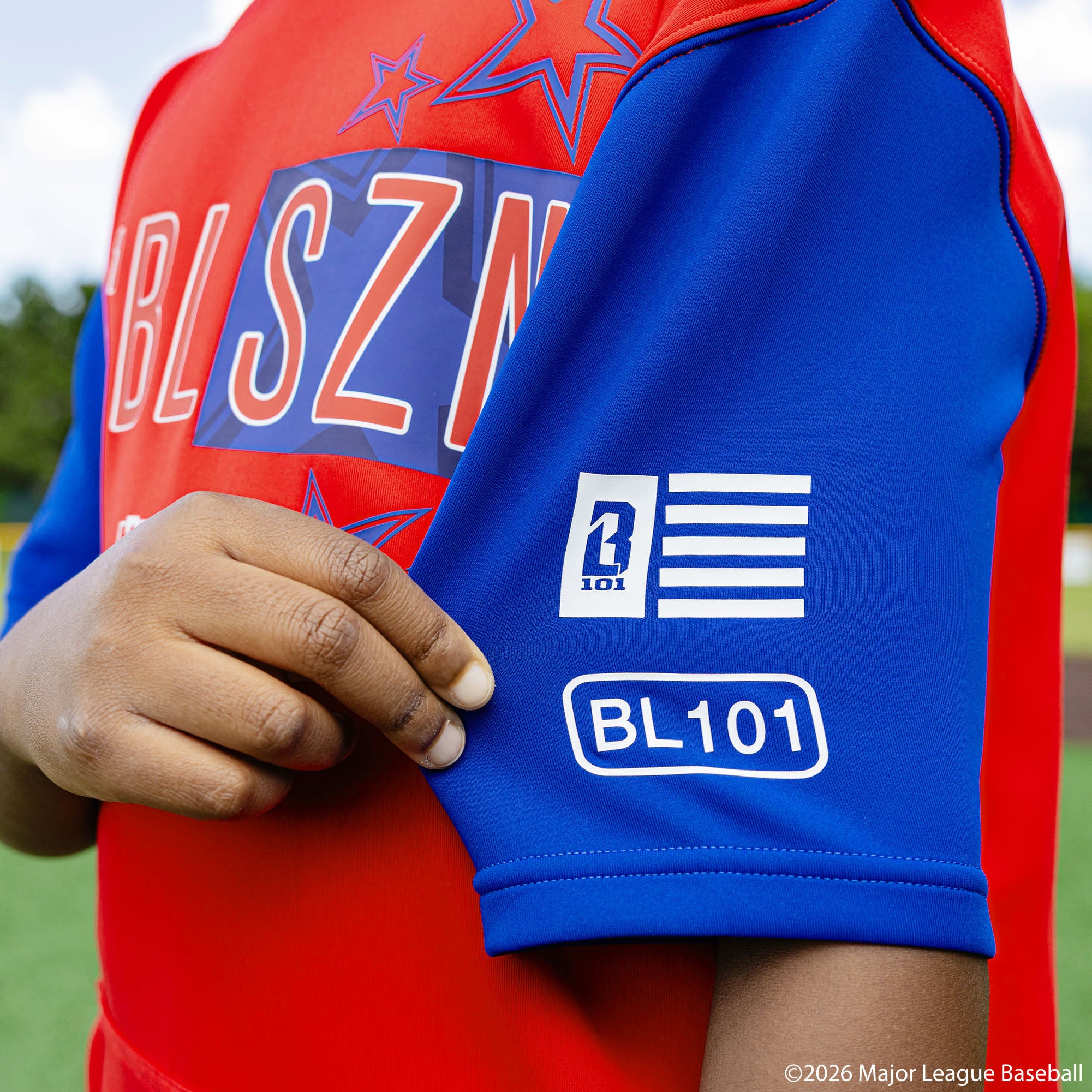 Youth model wearing Red, White & Blue youth short sleeve hoodie with "BL101 All-Star BSBL-SZN V3" design