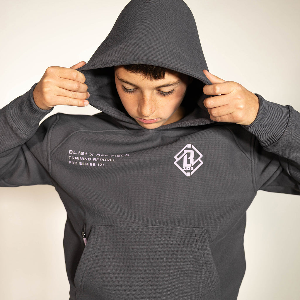 Youth model wearing gray and lilac Off-Field Waffle Performance youth hoodie