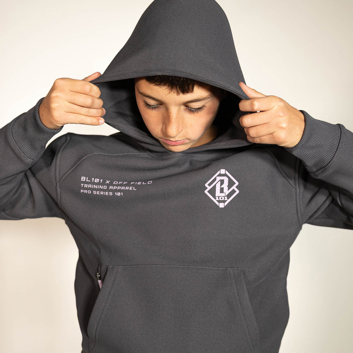 Youth model wearing gray and lilac Off-Field Waffle Performance youth hoodie