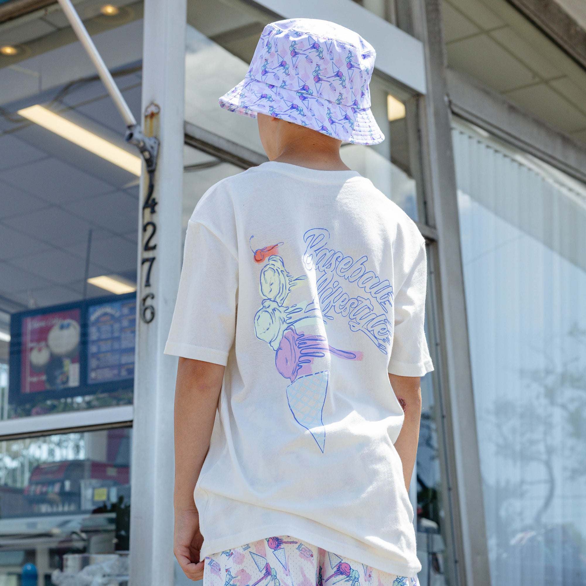 Adult model wearing hat with "Fastball Scoops Bucket" design