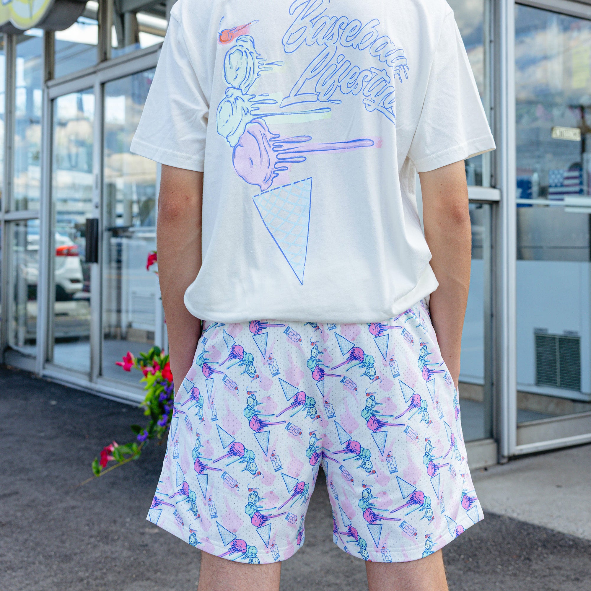 Adult model wearing shorts with "Fastball Scoops" design