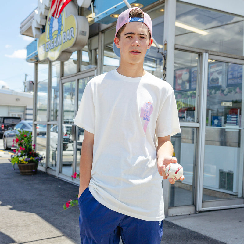 Adult model wearing cream Fastball Scoops graphic tee