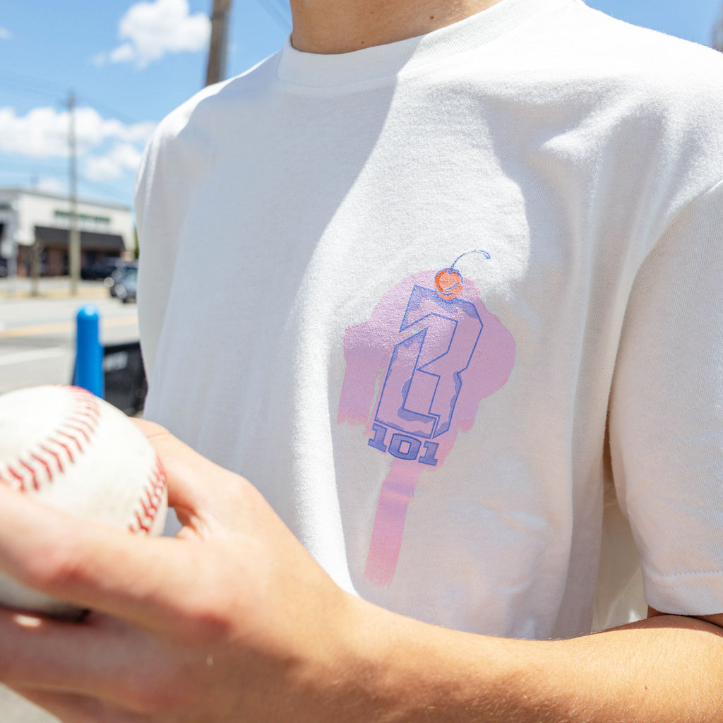 Adult model wearing cream Fastball Scoops graphic tee