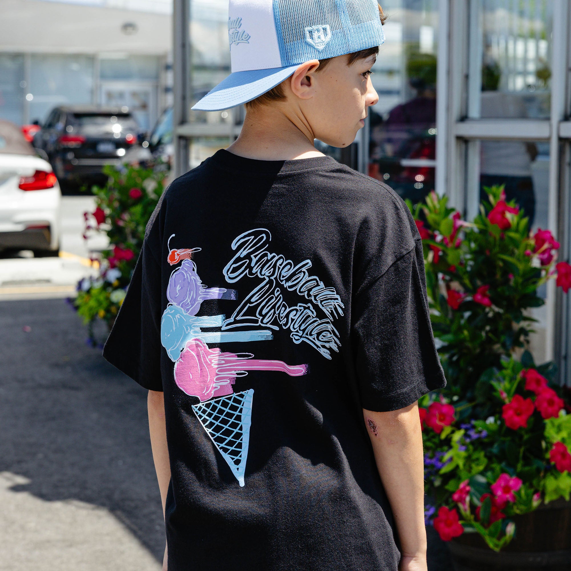 Youth model wearing black Fastball Scoops youth graphic tee