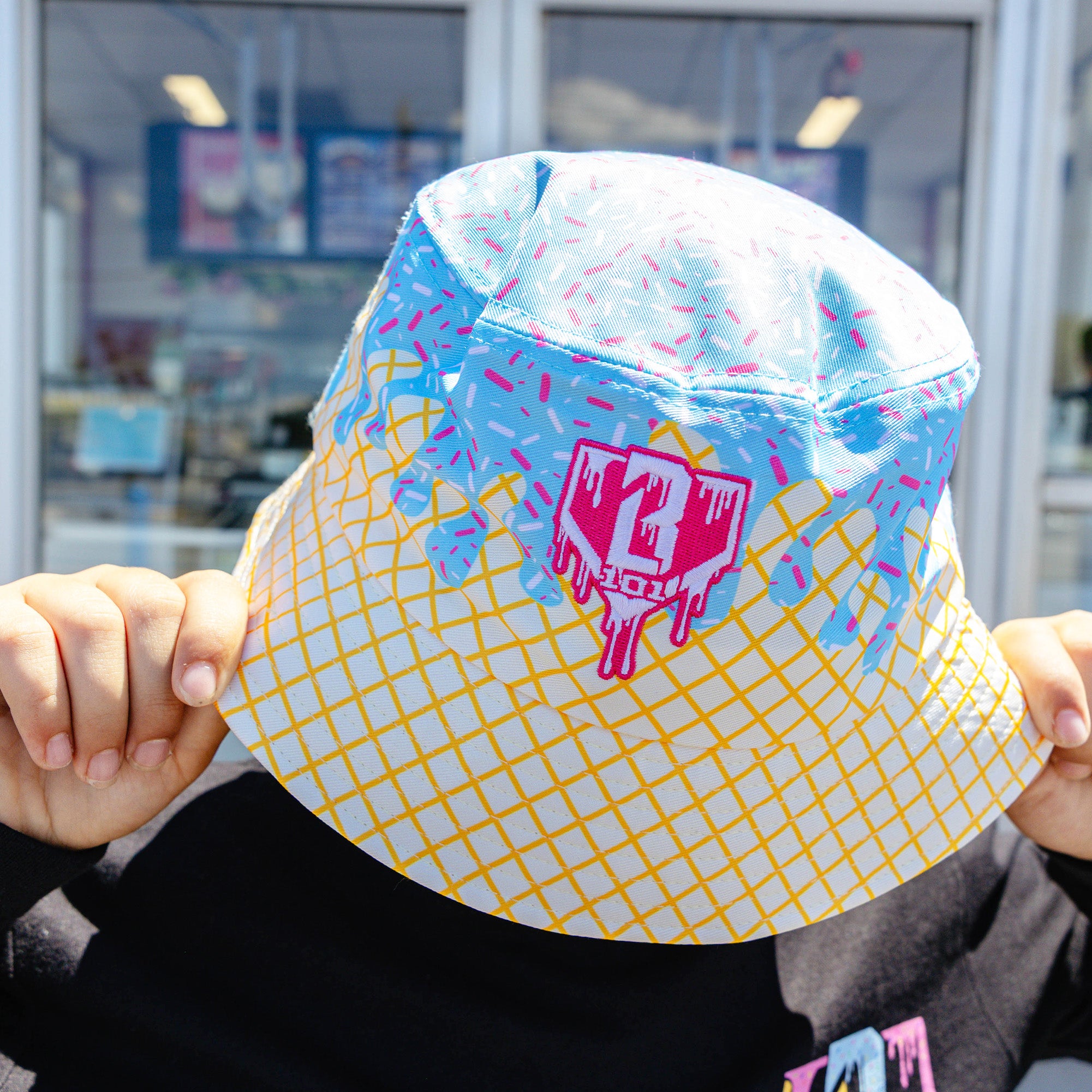 Adult model wearing hat with "Ice Cream Bucket" design