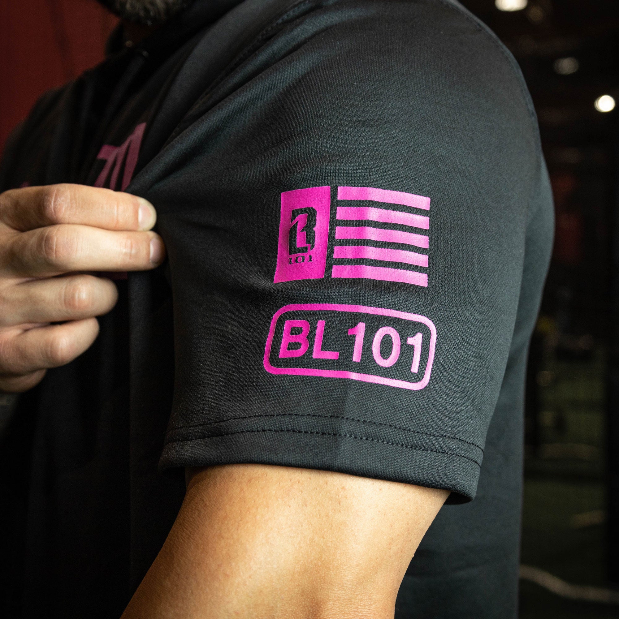 Youth model wearing black and pink BSBL-SZN youth short sleeve hoodie