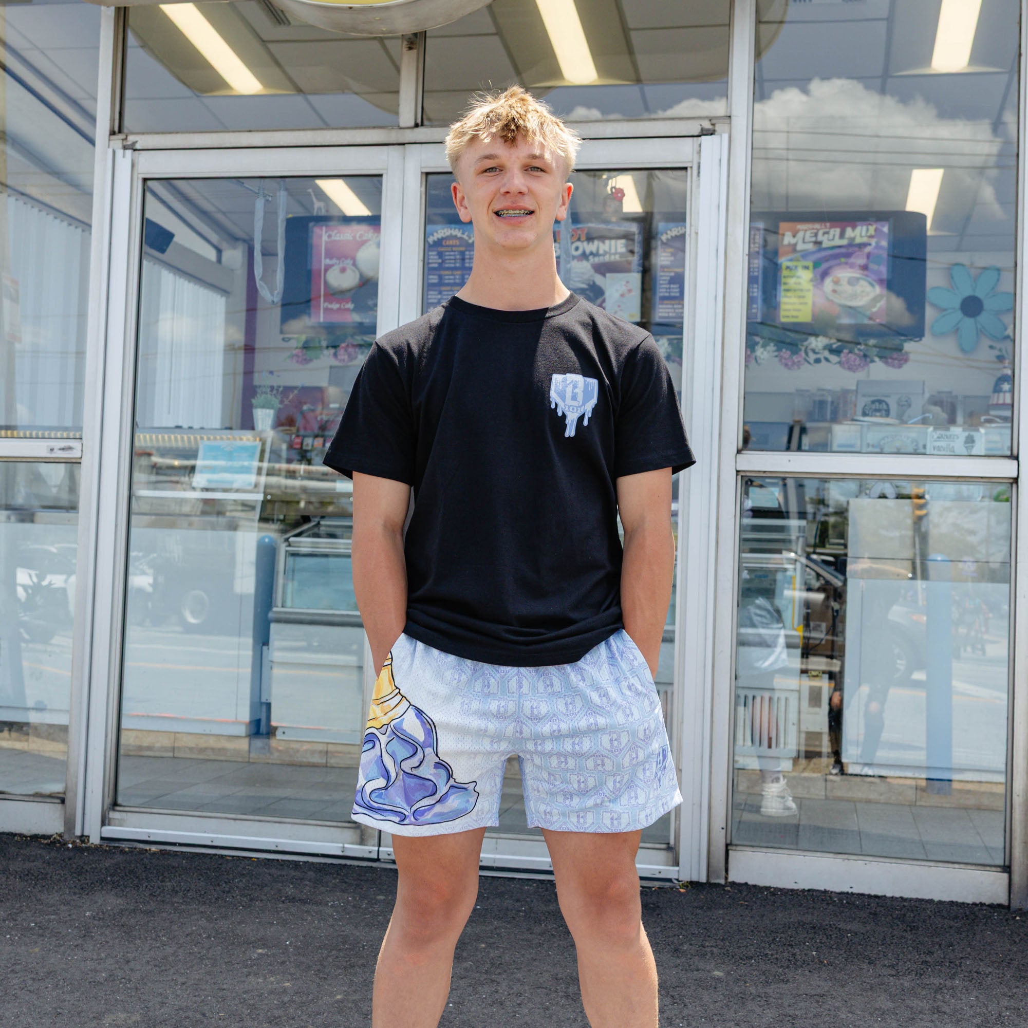 Adult model wearing shorts with "Scoop SZN" design