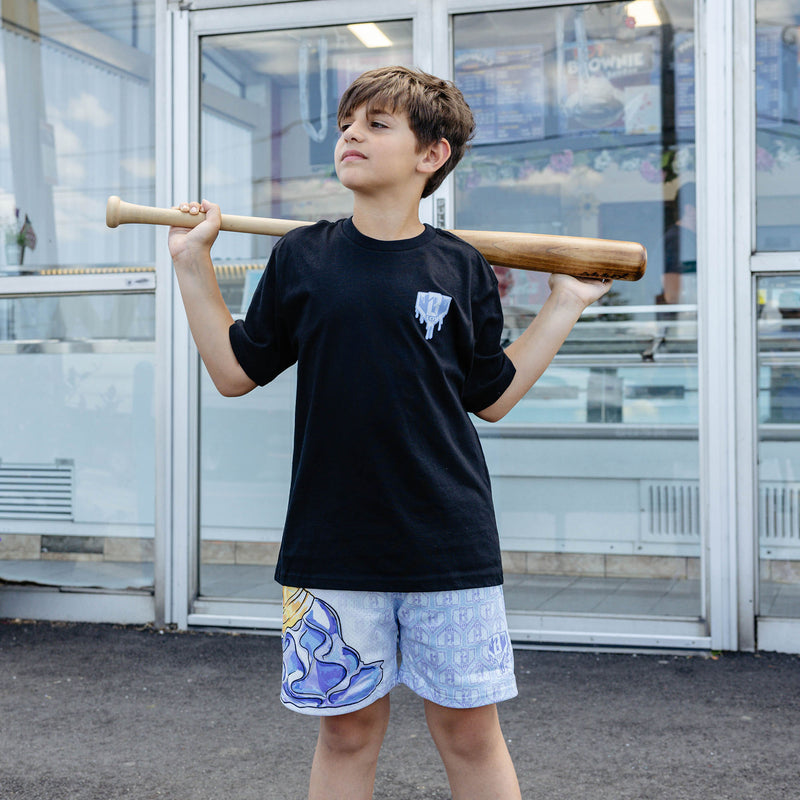 Youth model wearing youth shorts with "Scoop SZN" design