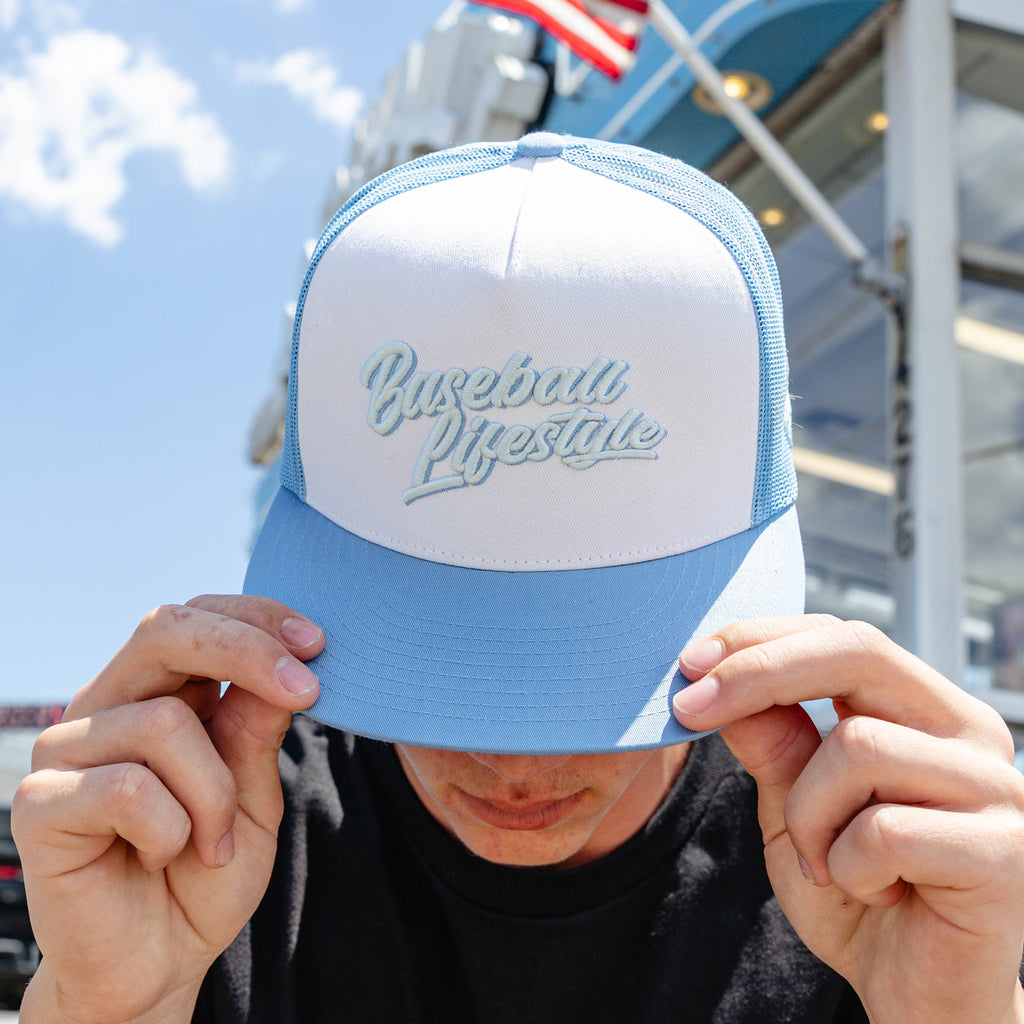 Adult model wearing white and blue Signature Off Field Snapback snapback