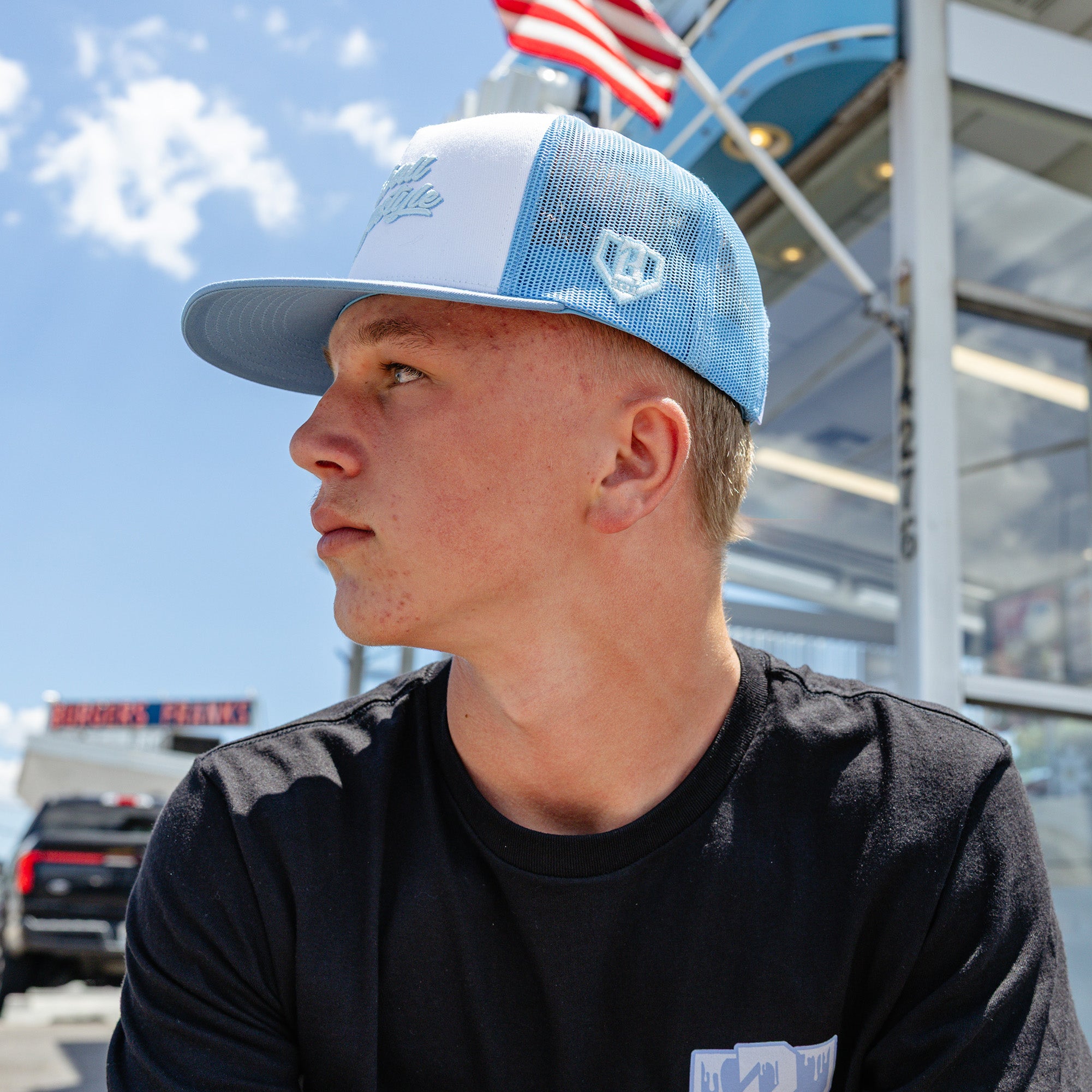 Adult model wearing white and blue Signature Off Field Snapback snapback