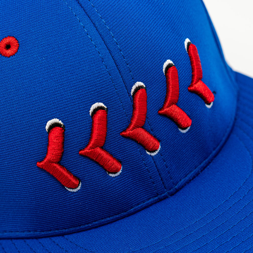 Close up of red stitching on blue fitted hat