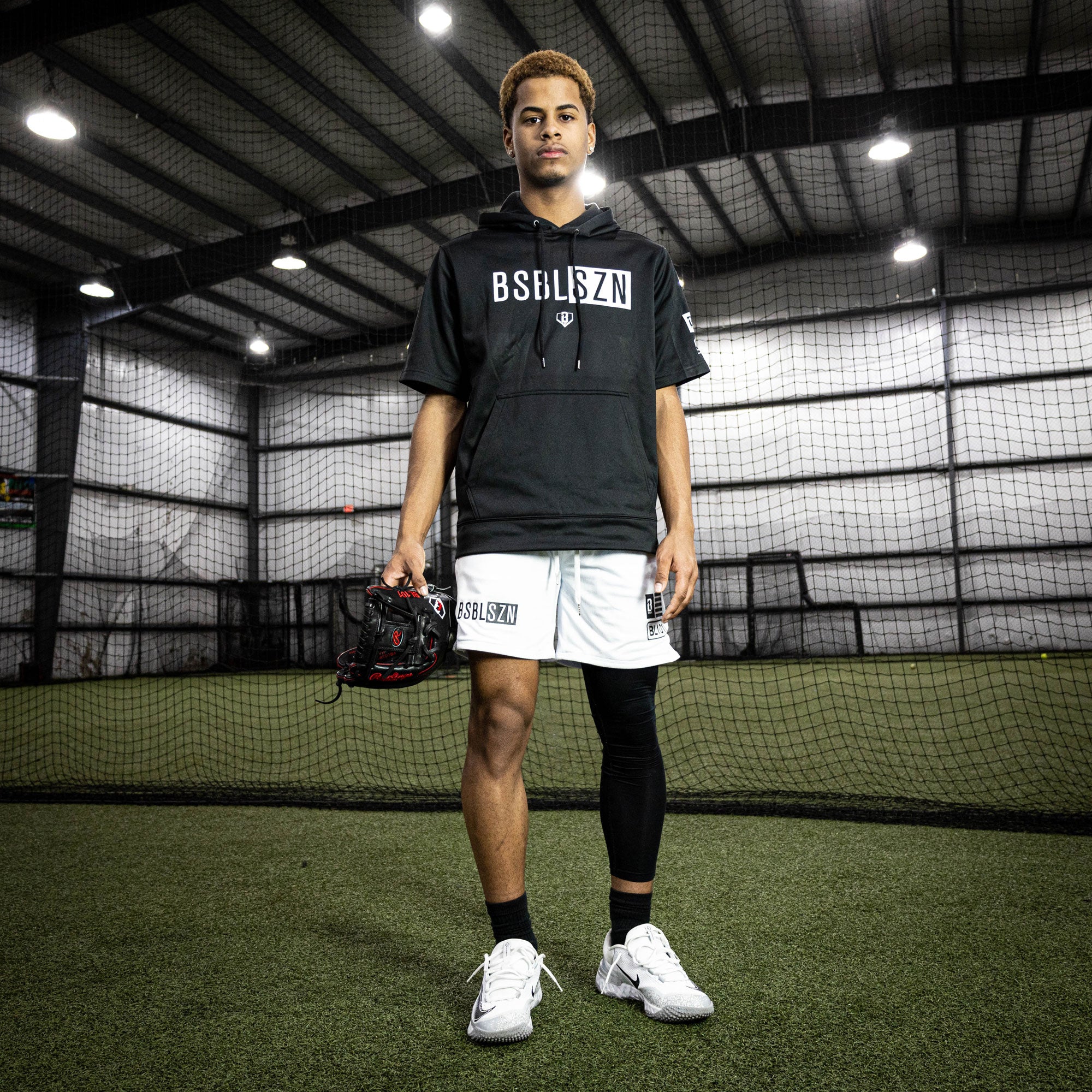 Adult model wearing black and white BSBL-SZN short sleeve hoodie