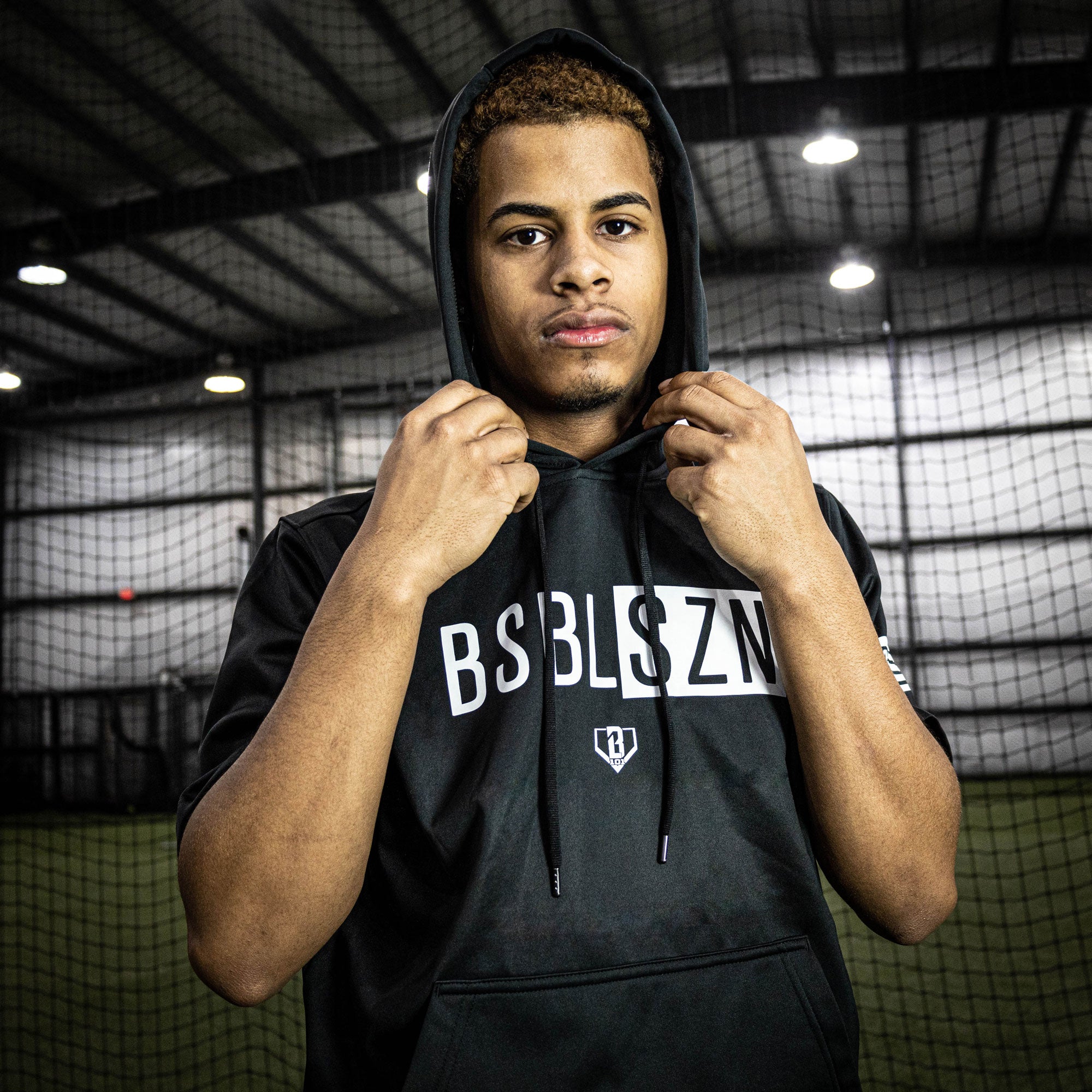 Adult model wearing black and white BSBL-SZN short sleeve hoodie